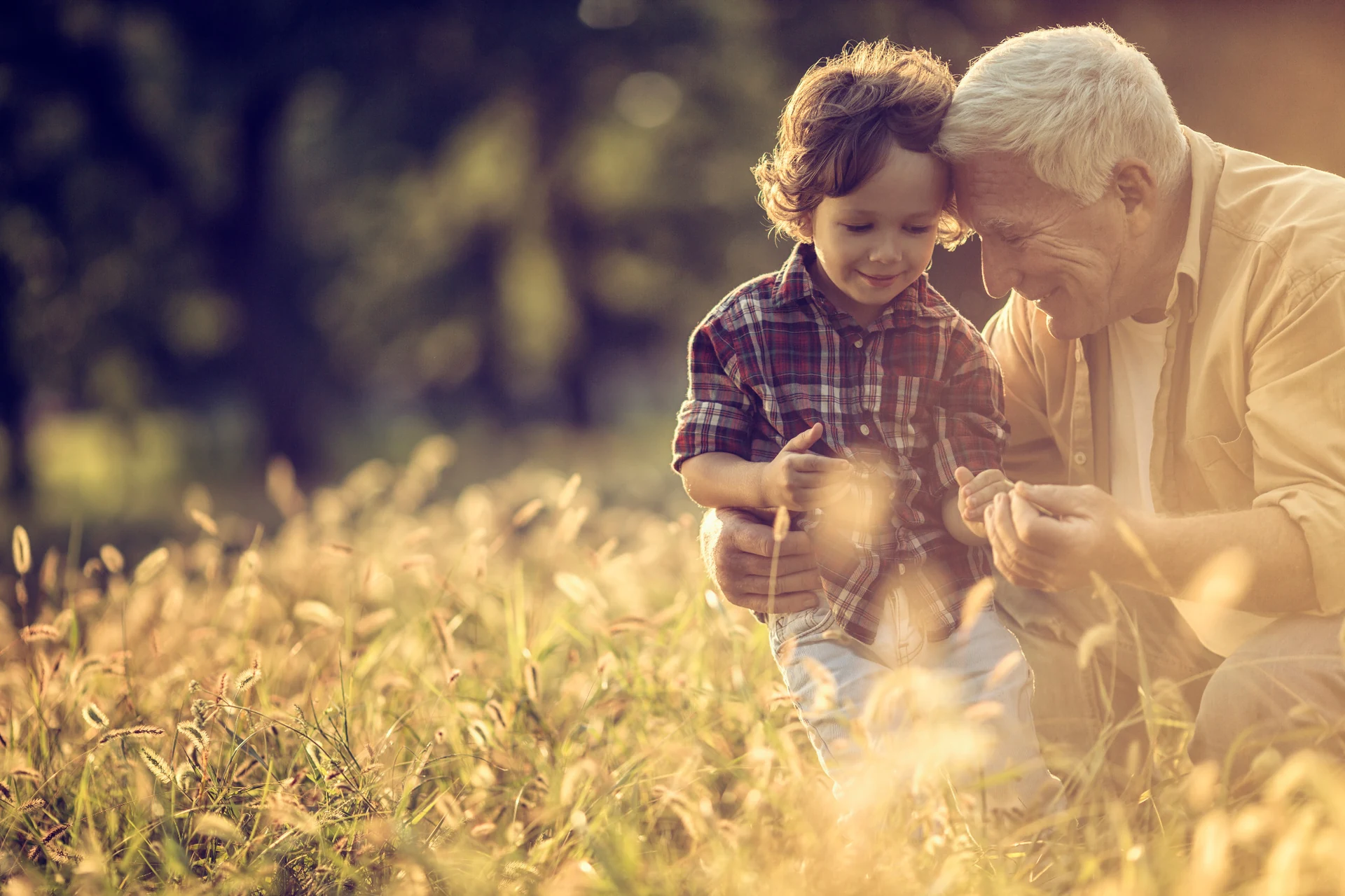 A grandfather and child sharing a quiet moment outdoors